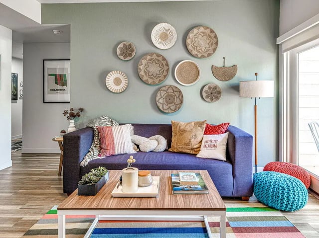 Blue couch decorative plates and coffee table living room at The Flats at Norman in Norman Student Accommodation