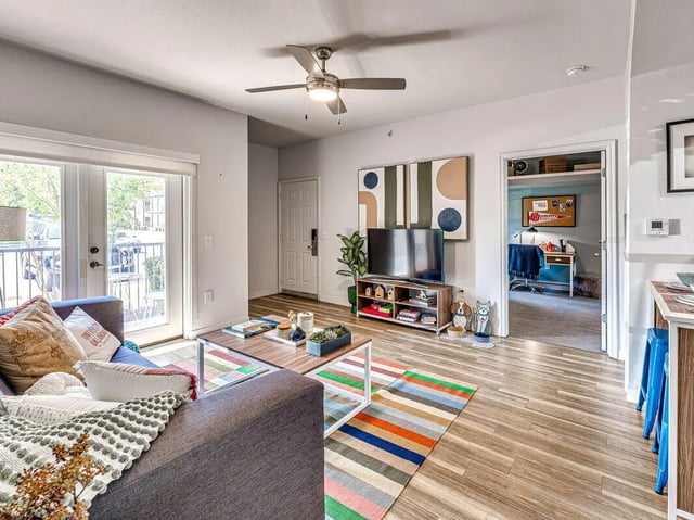 Sofa TV table rug and doors living room at The Flats at Norman in Norman Student Accommodation