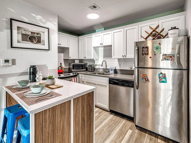 Small kitchen with white cabinets and stainless steel appliances kitchen at The Flats at Norman in Norman Student Accommodation