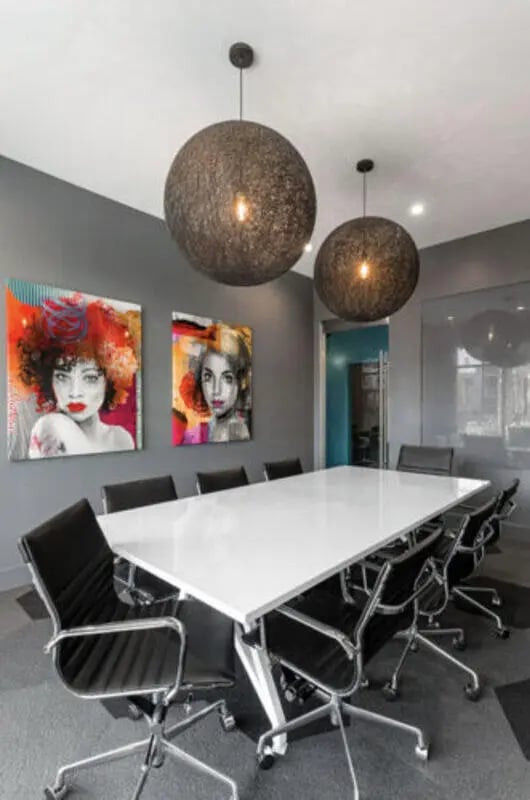 White conference table black chairs modern art meeting room at Stadium Enclave in Tallahassee Student Accommodation