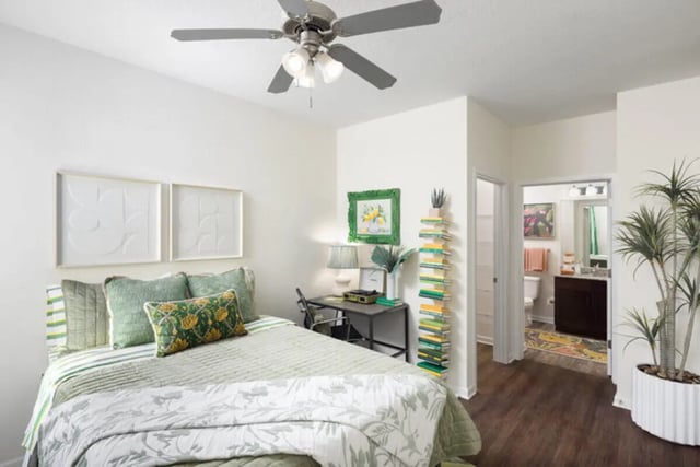 Bed with desk and bathroom beyond bedroom at Stadium Enclave in Tallahassee Student Accommodation