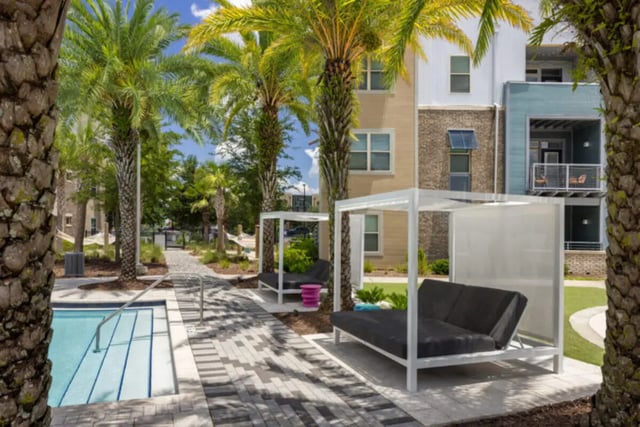Pool cabanas and lounge chairs exterior at Stadium Enclave in Tallahassee Student Accommodation