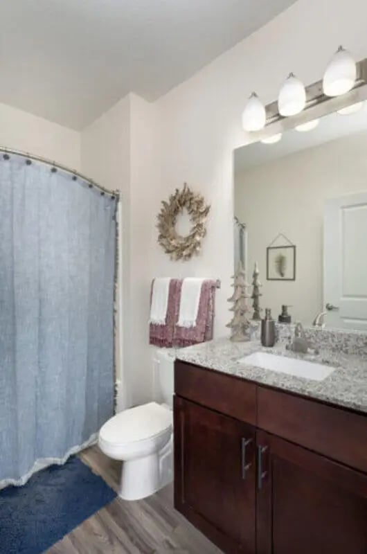 Toilet shower curtain wreath towels vanity sink bathroom at Stadium Enclave in Tallahassee Student Accommodation