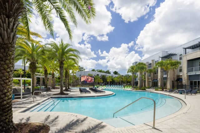 Resort style pool with lounge chairs exterior at Stadium Enclave in Tallahassee Student Accommodation