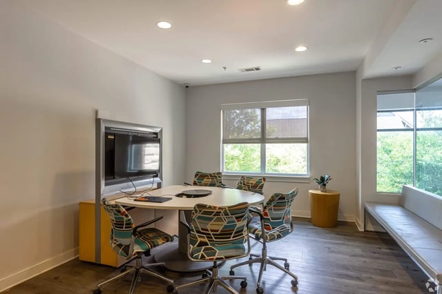 Round table and chairs near TV study area at Park East Student Living in Lubbock Student Accommodation