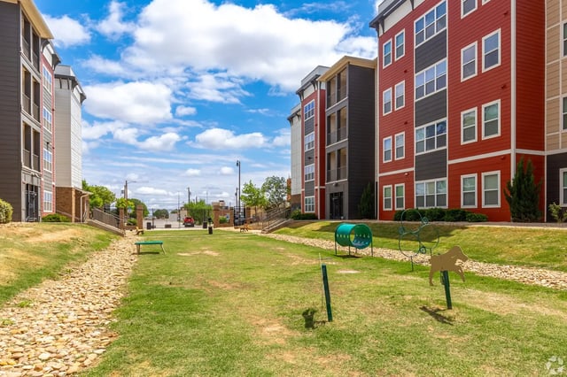 Apartment buildings with pet play area exterior at Park East Student Living in Lubbock Student Accommodation