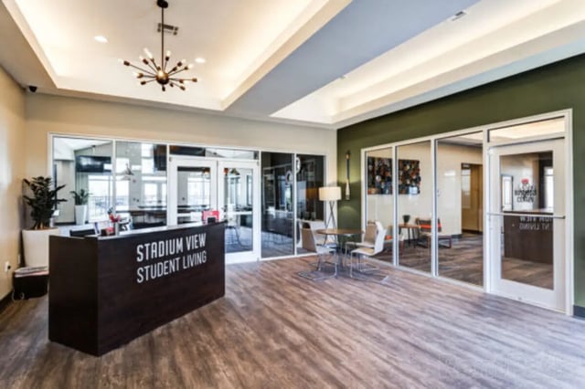 Reception desk with lounge seating student living area at Stadium View in Jonesboro Student Accommodation