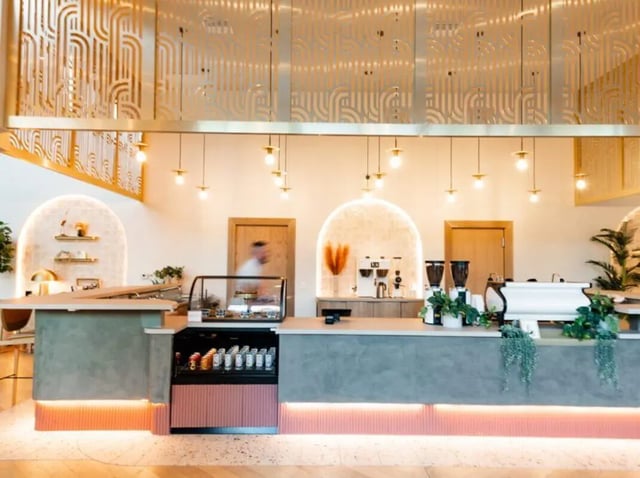 Coffee counter display cases and espresso machines cafe at Sweetwater Gainesville Apartments in Gainesville Student Accommodation
