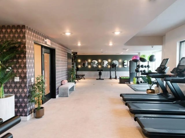 Treadmills weight rack bench gym area at Sweetwater Gainesville Apartments in Gainesville Student Accommodation