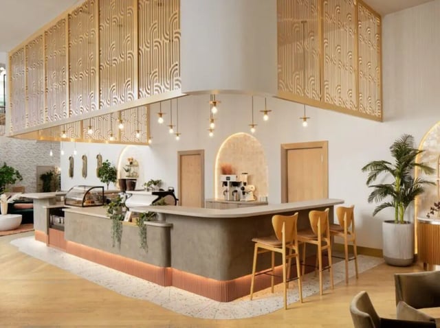 Bar with coffee machine and chairs common area at Sweetwater Gainesville Apartments in Gainesville Student Accommodation