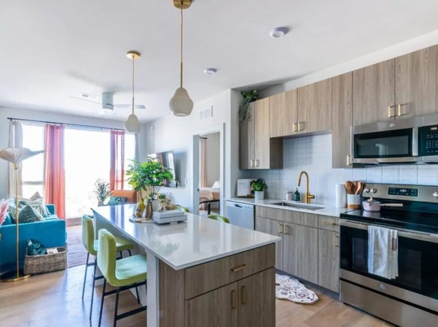 Open plan kitchen and living area with island at Sweetwater Gainesville Apartments in Gainesville Student Accommodation