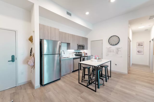 Stainless steel fridge island with stools kitchen at Lapis in Miami Student Accommodation