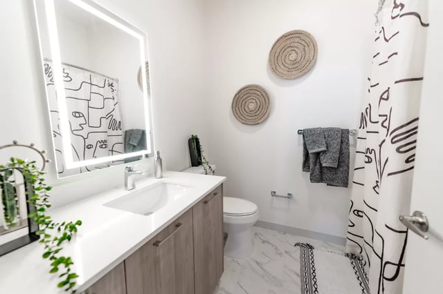 Modern bathroom vanity toilet shower curtain decorative baskets bathroom at Lapis in Miami Student Accommodation