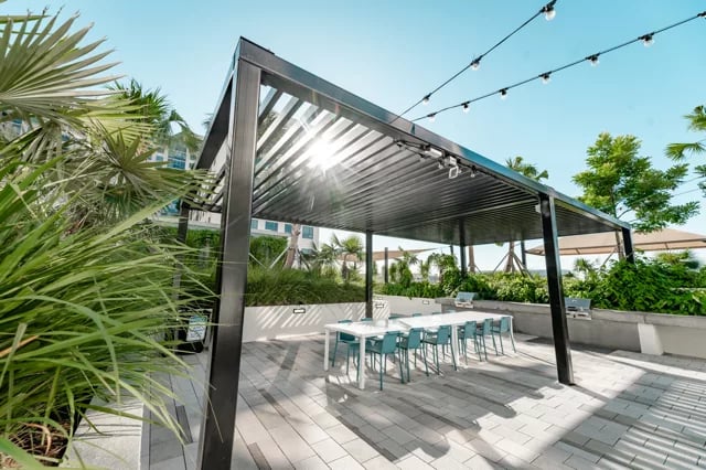 Outdoor dining area with white table and chairs outdoor living space at Lapis in Miami Student Accommodation