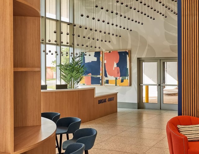 Wooden reception desk art chairs building lobby at Lapis in Miami Student Accommodation