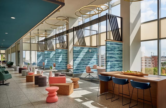 Modern communal lounge with seating and bar living room at Lapis in Miami Student Accommodation