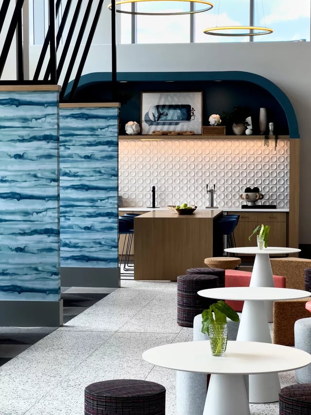 Modern lounge with round tables and stools communal area at Lapis in Miami Student Accommodation