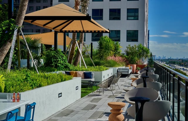 Outdoor seating and plants on rooftop terrace Exterior at Lapis in Miami Student Accommodation