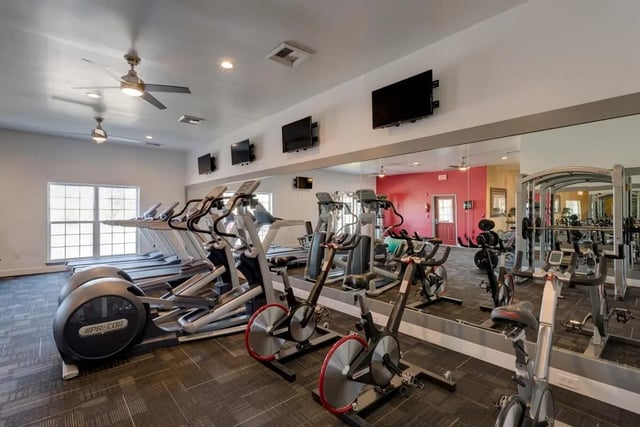 Treadmills ellipticals stationary bikes gym fitness area at The Grove Apartments Cheney in Cheney Student Accommodation