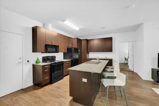 Modern kitchen with island and stools kitchen at The Cardinal at West Center in Fayetteville Student Accommodation