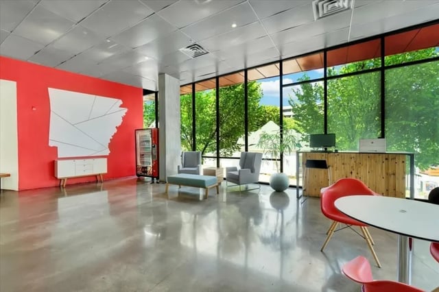 Lobby with seating and reception desk communal area at The Cardinal at West Center in Fayetteville Student Accommodation