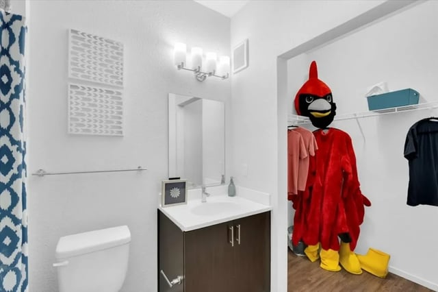 Toilet sink cabinet towel rack mascot bathroom at The Cardinal at West Center in Fayetteville Student Accommodation