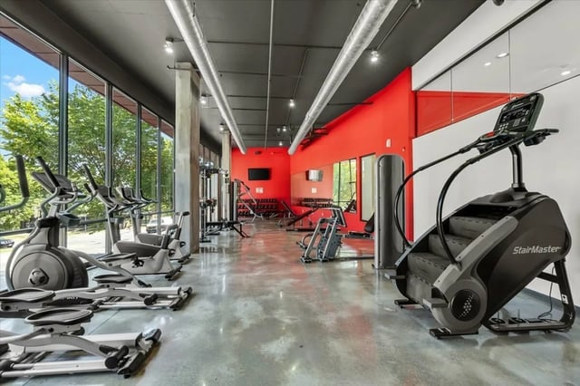 Ellipticals stair climber and weights fitness room at The Cardinal at West Center in Fayetteville Student Accommodation
