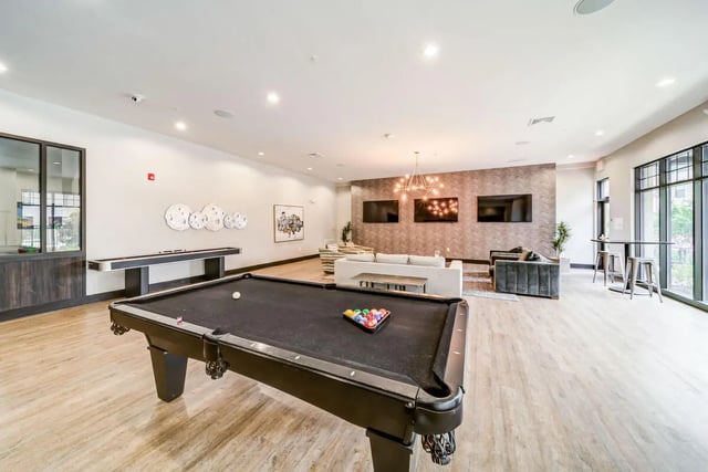Pool table shuffleboard and lounge area living room at University Edge and Dickinson Lofts in Greenville Student Accommodation