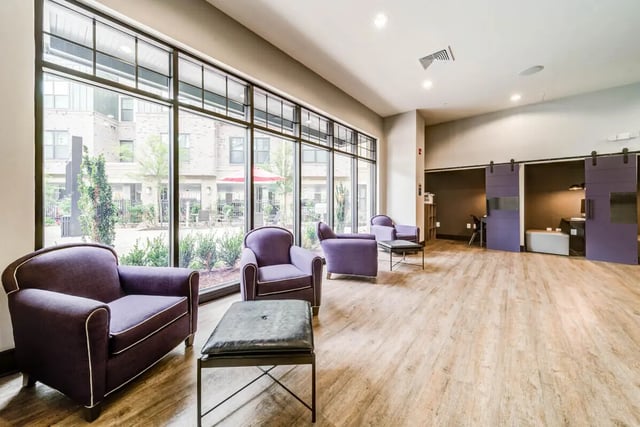 Purple armchairs and ottomans living area at University Edge and Dickinson Lofts in Greenville Student Accommodation