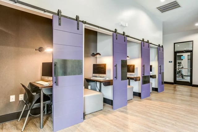 Computers at desks with sliding purple doors study area at University Edge and Dickinson Lofts in Greenville Student Accommodation