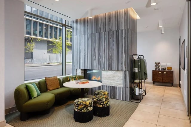 Green couch circular table fireplace living room at ACE Berkeley Student Apartments in Berkeley Student Accommodation