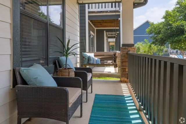 Chairs swing and rug on porch exterior at The Village on Telluride in San Marcos Student Accommodation