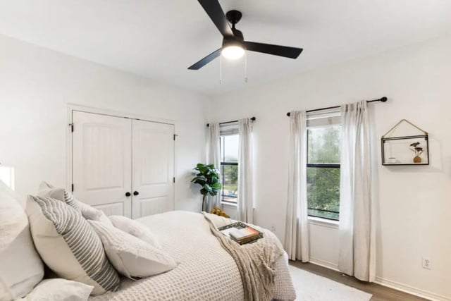 Bed with pillows ceiling fan and wardrobe bedroom at The Village on Telluride in San Marcos Student Accommodation