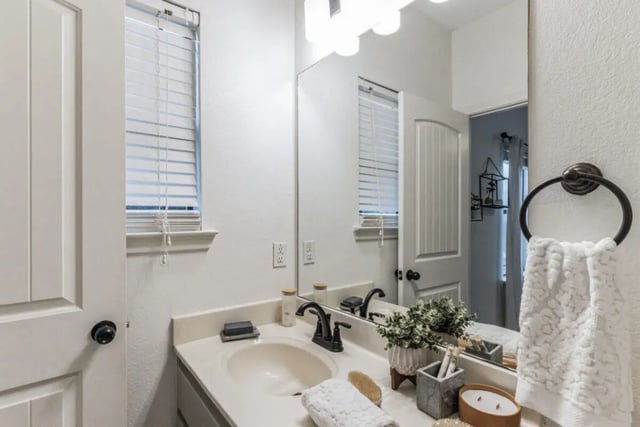 Sink vanity with towels soap and plants bathroom at The Village on Telluride in San Marcos Student Accommodation