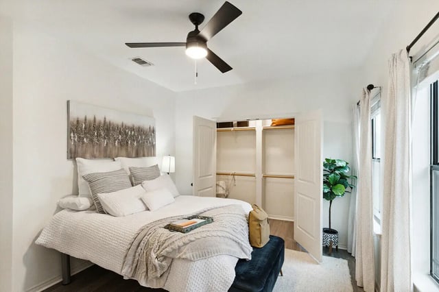 Bed fan closet open plant bedroom at The Village on Telluride in San Marcos Student Accommodation