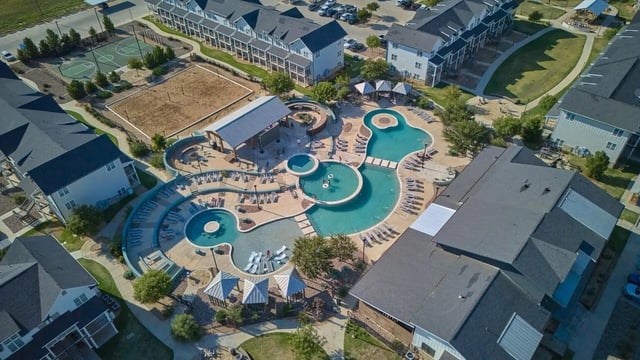 Resort-style pool with lounge chairs and cabanas exterior at Wildwood Lubbock in Lubbock Student Accommodation