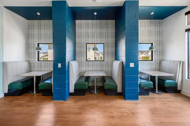 Booths and tables with windows lounge area at Wildwood Lubbock in Lubbock Student Accommodation
