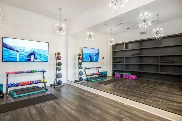 Dumbbells yoga mats step benches gym gym at Wildwood Lubbock in Lubbock Student Accommodation