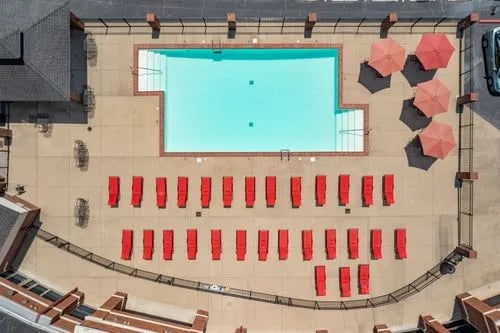 Pool lounge chairs and umbrellas outdoor area exterior at Registry Apartments in Bowling Green Student Accommodation