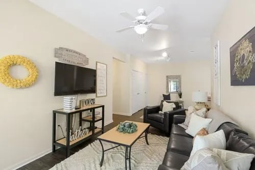 Living room with television couch and chairs living room at Registry Apartments in Bowling Green Student Accommodation