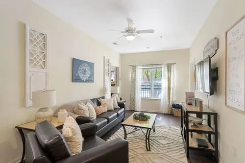Leather sectional sofa coffee table rug living room at Registry Apartments in Bowling Green Student Accommodation