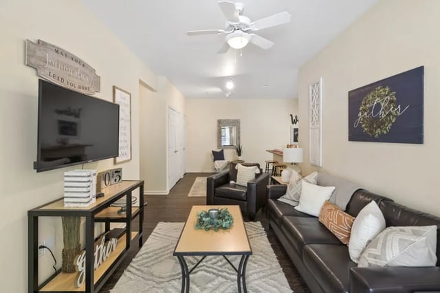 TV leather sofa coffee table living room at Registry Apartments in Bowling Green Student Accommodation