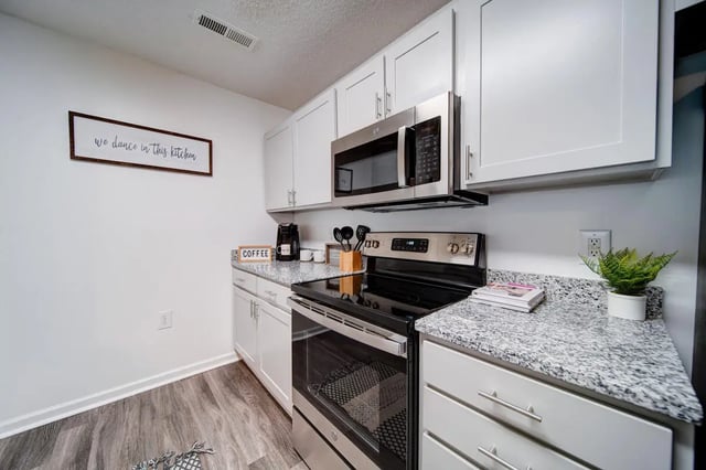 White cabinets microwave oven and stove kitchen at The Everson in Cullowhee Student Accommodation
