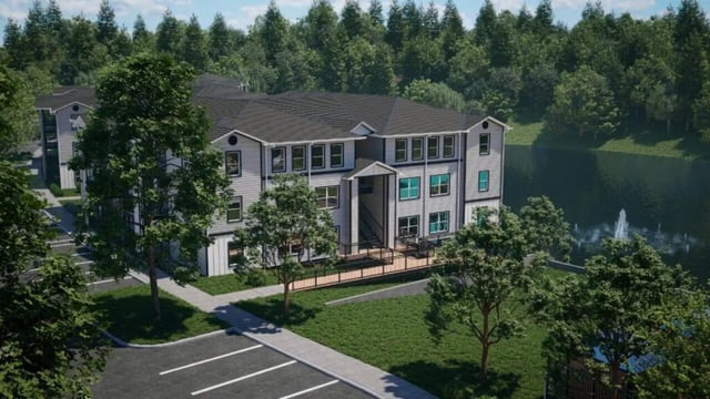 Apartment building with lake and fountain exterior at The Asher in Tallahassee Student Accommodation