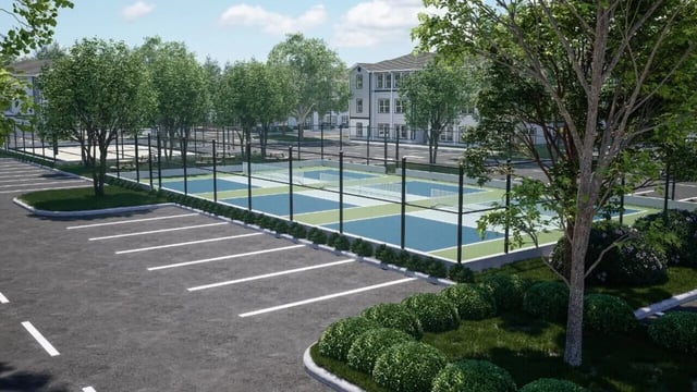 Outdoor pickleball courts next to parking lot exterior at The Asher in Tallahassee Student Accommodation