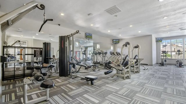 Weight machines and treadmills in a gym. at The Asher in Tallahassee Student Accommodation