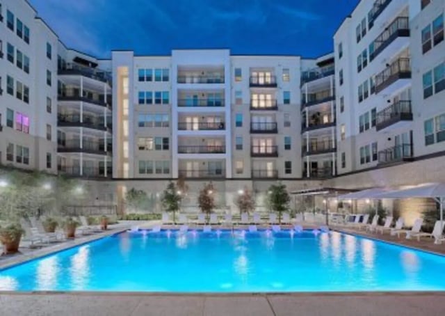 Apartment complex with pool lounge chairs exterior at 101 Center in Arlington Student Accommodation