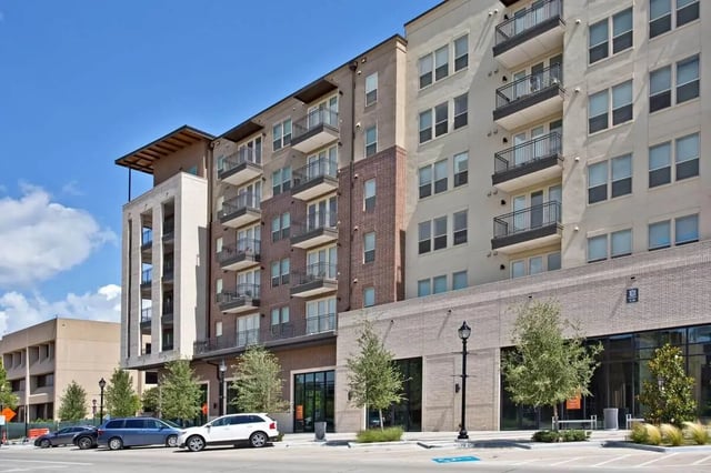 Modern apartments with balconies and street view exterior at 101 Center in Arlington Student Accommodation