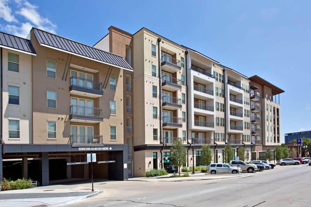 Multi-story apartment building with balconies parking garage exterior at 101 Center in Arlington Student Accommodation