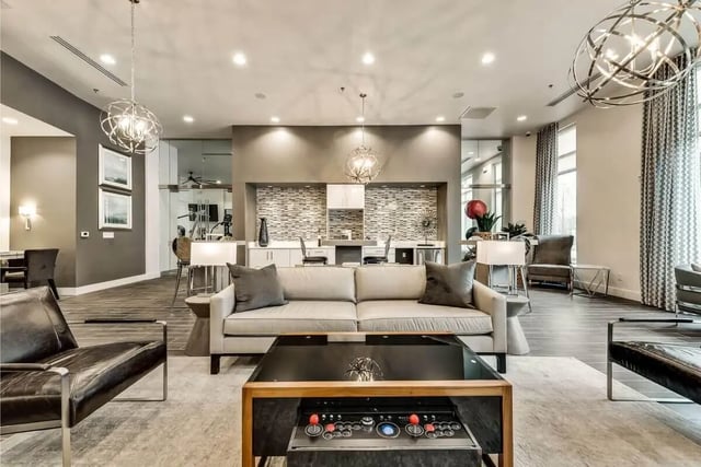 Sofa coffee table arcade cabinet gym living room at 101 Center in Arlington Student Accommodation